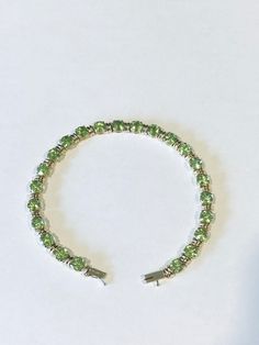 You are looking at a exceptionally well-crafted 14kt yellow gold peridot bracelet that is in excellent condition. The bracelet consists of round shape peridot stones that are each separated by a gold link. The peridot stones are faceted which allows them to shine at maximum capacity; the stones which have a light green color to them, are in very good condition. The bracelet is 7.25 inches in length and weighs 9.5 grams. The gold content of the bracelet has been tested by acid and is guaranteed to be 14kt yellow gold. Please message me if you have any questions. Purchase with confidence! Peridot Bracelet, Peridot Stone, Fine Jewelry Bracelets, Bracelets And Charms, Light Green, Green Colors, Jewelry Watches, Jewelry Bracelets, Fine Jewelry