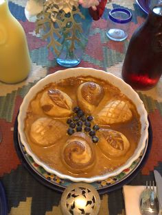 a bowl of food on a table with silverware