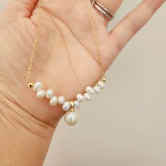 This Handmade freshwater pearl necklace, pearl statement necklace, pearl pendant, Artisan gold and pearl necklace, Baroque pearl chain necklace looks so unique and pretty. It is made with Freshwater seed pearls (4-5mm) and a 9-11mm freshwater Edison pearl as the pendant. The chain is 18k vacuum-plated on stainless steel, which is tarnish-resistant and allergy approval. The seed pearls are displayed in a way that resemble a stalk of wheat. This natural, organic arrangement adds to the necklace's Gold And Pearl Necklace, Pearl Statement Necklace, Edison Pearls, Pearl Chain Necklace, Freshwater Pearl Necklace, Necklace Pearl, Wedding Jewellery Necklace, Freshwater Pearl Necklaces, Pearl Chain