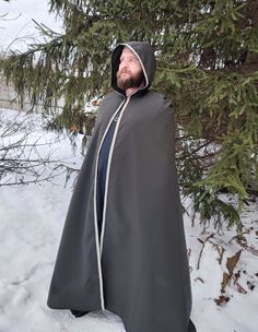 "Shop now Long medieval hooded cloak for men! Medieval hooded cloak in dark green with beautiful trim embellishment. Awesome Medieval prince' cape, viking cloak, elven hooded cape. Just perfect for LARP events, viking festivals, renfaire events etc. See more hooded cloaks here https://www.etsy.com/shop/EthnicandMedieval?ref=seller-platform-mcnav&section_id=35034993 The length (top shoulder to hem) - 59\" (150 cm).  The fabric is a lightweight polyester, really stunning colour. It has a velvet sh Elvish Hooded Costume Outerwear, Elvish Hooded Cape For Larp, Hooded Winter Cape For Fantasy Events, Hooded Cape For Fantasy Events In Winter, Gothic Hooded Cape For Larp, Halloween Cape Outerwear For Larp, Halloween Cape For Larp Events, Halloween Cape For Larp, Hooded Medieval Cape For Larp