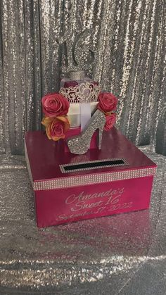 a pink shoe box with roses in it on top of a silver sequin table cloth