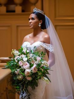 a woman in a wedding dress holding a bouquet