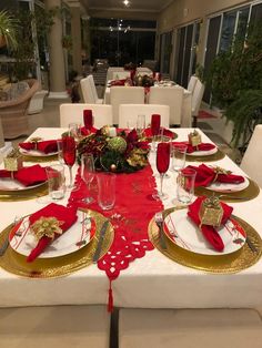 the table is set with red and gold place settings