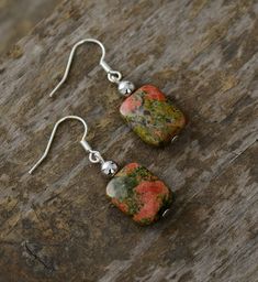 These lovely earrings are made from Unakite Jasper, and is said to symbolize "what comes together belongs together." Wear these to dress up any outfit - day or night! Since each natural stone is unique (just like you ❤️), colors and shape will vary slightly from earring to earring, making this beautiful handmade item truly one of a kind. Coast Cowgirl, Layered Beaded Necklaces, Natural Stone Earrings, Hippie Earrings, Feather Necklaces, Beaded Choker Necklace, Chic Jewelry, Lovely Earrings, Beaded Choker