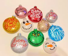 a collection of christmas ornament ornaments on a white surface with the words happy new year written on them