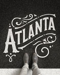 a black and white photo with the word atlanta on it in cursive writing