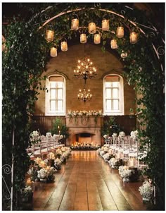 an indoor wedding venue with candles and greenery