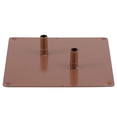 two copper colored pipes are on top of a metal plate with holes in the middle