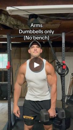 a man standing in front of a gym equipment rack with dumbbells on it