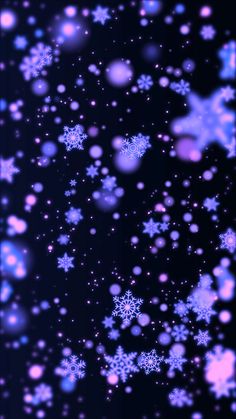 blue and pink snowflakes are flying in the air