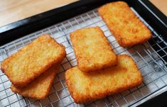 some fried food is sitting on a cooling rack and ready to be cooked in the oven