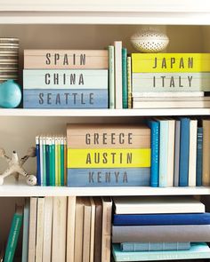 several books are stacked on top of each other in a bookcase with the words japan, china, seattle and greece