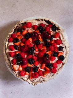 a pie with strawberries, raspberries and blackberries on top