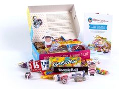 a box filled with lots of candy next to a card and some stickers on it