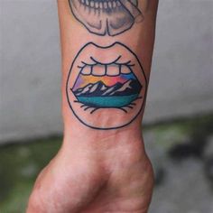 a person's hand with a tattoo on it and a skull in the middle