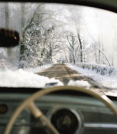 a car driving down a snow covered road