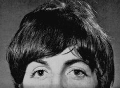 an old black and white photo of a woman with short hair smiling at the camera