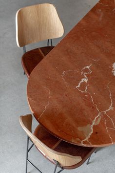 three wooden chairs and a marble top table