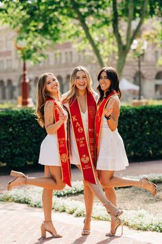 three beautiful young women standing next to each other wearing red sashes and high heels