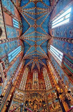 the inside of an ornate building with blue and gold paint