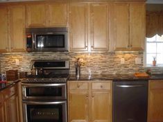 a kitchen with wooden cabinets and stainless steel appliances