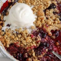 a close up of a bowl of food with fruit and ice cream on top,