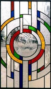 a close up of a stained glass window with an abstract design in the center and bottom