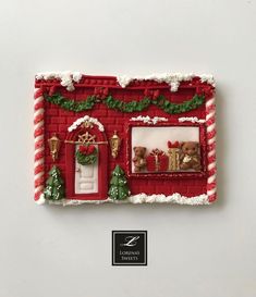 a red and white gingerbread house decorated for christmas