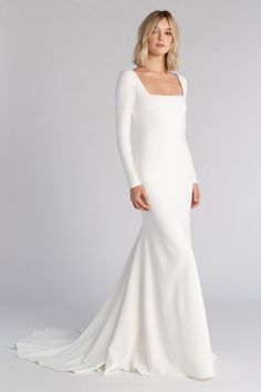 a woman in a white wedding dress with long sleeves and an open back, posing for the