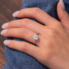 a woman's hand with a diamond ring on it