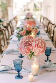 a long table with flowers and candles on it