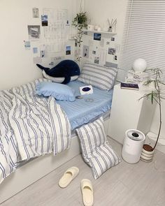 a bed room with a neatly made bed and two shoes on the floor next to it