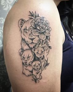 a woman's arm with an image of animals and flowers on the back of her shoulder