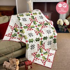 a christmas quilt is on the floor next to a fire place and fireplace mantel