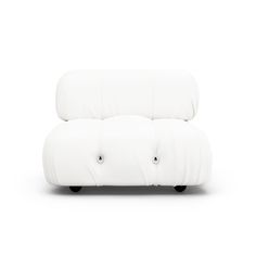 a white couch sitting on top of a white floor