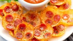 pepperoni and cheese appetizers on a plate with dipping sauce