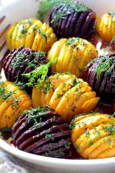 a white bowl filled with beets covered in herbs