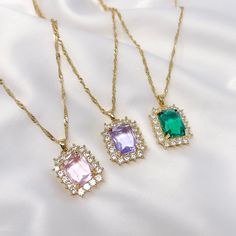 "This listing is for one resizable/adjustable pink, purple, or emerald green faceted rhinestone charm necklace with gold plated twist chain. This necklace is made with a brass base, gold plating, and a small gold plated stainless steel charm at the end of the extension chain. Chain is 16.5\" long with a 3.5\" extension. The maximum length of the necklace is 20\"." Trendy Cubic Zirconia Clavicle Chain Necklace, Trendy Jewelry Gift, Adjustable Jeweled Crystal Necklaces, Trendy Jeweled Necklaces As Gifts, Gold Dangle Necklaces With Sparkling Stones, Party Pendant Crystal Necklace With Adjustable Chain, Trendy Gold Crystal Necklaces, Cubic Zirconia Dangle Rhinestone Necklace For Gift, Dainty Crystal Necklace With Rhinestones