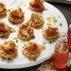 there are many small appetizers on the plate next to a bottle of soda