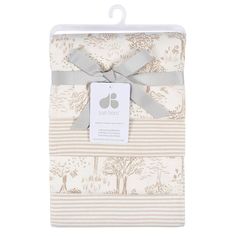 the baby blanket is wrapped in beige and white stripes with a bow at the top