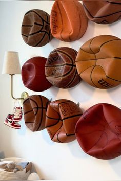 there are many basketballs hanging on the wall