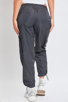 Somedays, getting dressed should just be easy. With a straightforward design, our Women’s High Rise Nylon Cargo Jogger is a true no-fuss pant. These high waisted pants feature an elasticized waistband with an adjustable bungee cord for customizable comfort and fit. They have subtle slant front pockets, side flap cargo pockets, and adjustable bungee hems for a cinched look at the ankle. Pair with a ribbed tank and sneakers for an everyday sporty look, or heels and a bodysuit for something more pl Ymi Jeans, Bungee Cord, Getting Dressed, Cargo Joggers, Cargo Pant, Ribbed Tank, Sand Color, Sporty Look, Baggy Fits