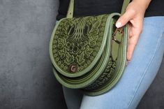 "Olive bag ladies, green shoulder bag, round leather bag, green leather purse, crossbody bag, tooled olive bag, gift for her, embossed bag Model \"Guelder rose\" Unique handmade bag made of premium 4 mm genuine calf leather. Made using rare technology of hot tooling. Super comfortable, durable and functional. Has one big compartment, one internal zip-pocket and one button pocket, e.g. for cell phone or keys. 22x20x8 cm (8.3x7.9х3.1 in) Strap length 140 cm (55 in) Please note! Since each item in 2024 Handbags, Guelder Rose, Unique Leather Bag, Green Shoulder Bag, Unique Backpacks, Ethnic Bag, Embossed Bag, Green Purse, Bags Leather Handbags