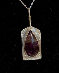 "Handmade sterling and deep purple amethyst necklace with a teardrop stone and shaped silver backplate.  Amethyst is a February birthstone, but this is fashionable all year round.  Pendant measures 1 3/8\" long and has a 3/4\" peanut shaped bail that is wrapped in fine silver wire.  Beautifully hand textured for extra shine and sparkle.   Comes with a 18\" sterling silver chain. Thank you for visiting Studio729!  I welcome your questions and business.  To see more of my handmade jewelry, just cl Spiritual Nickel-free Teardrop Necklace, Amulet Style Teardrop Gemstone Jewelry, Amulet Style Jewelry With Teardrop Gemstone, Bohemian Sterling Silver Teardrop Pendant Necklace, Spiritual Teardrop Pendant Jewelry, Spiritual Sterling Silver Teardrop Necklace, Silver Amethyst Teardrop Jewelry, Silver Teardrop Amethyst Jewelry, Hand Forged Drop Jewelry As Gift