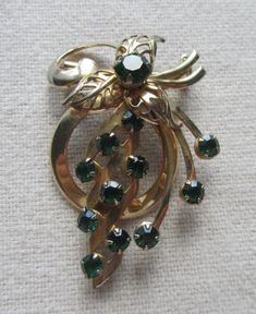 "Vintage gold tone pendant flower brooch with green rhinestones. It measure 2\" x 1 1/2\" and it is in good condition. SHIPPING: Ready to ship within 1-2 business days of payment. Please take note that shipping is by regular mail with Canada Post, no tracking. If you would like tracking please let me know and will provide cost." Antique Green Brooch For Anniversary, Antique Green Brooches For Anniversary, Green Costume Jewelry Brooches For Gift, Green Costume Jewelry Brooches For Gifting, Canada Post, Rhinestone Brooches, Flower Brooch, Vintage Gold, Antique Jewelry