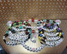 several bracelets are arranged on top of each other in the shape of letters that spell out words