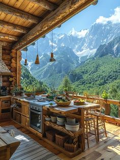 an outdoor kitchen and dining area with mountains in the backgrounnd, surrounded by wood flooring