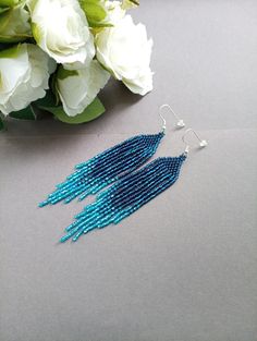 "These blue beaded Dangle earrings pair amazingly with any outfit, dressy or casual.  They are made of high-quality Czech colored beads with steel . Colors: blue Length: 4.5 inches (11.5 cm) Width: 0.8 inches (2 cm) Materials: Czech \"Preciosa\" beads Durable synthetic thread" Blue Beaded Tassel Dangle Earrings, Blue Fringed Beaded Drop Earrings, Blue Beaded Fringe Tassel Earrings For Summer, Blue Fringe Beaded Drop Earrings, Bohemian Blue Long Drop Beaded Earrings, Blue Tassel Earrings With Dangling Beads For Summer, Blue Tassel Earrings With Colorful Beads For Summer, Summer Blue Beaded Earrings With Tassels, Summer Blue Tassel Earrings With Colorful Beads