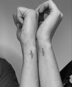 two people with matching tattoos on their arms