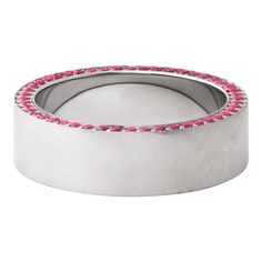 a wedding band with pink stones in the center and silver finish, on a white background